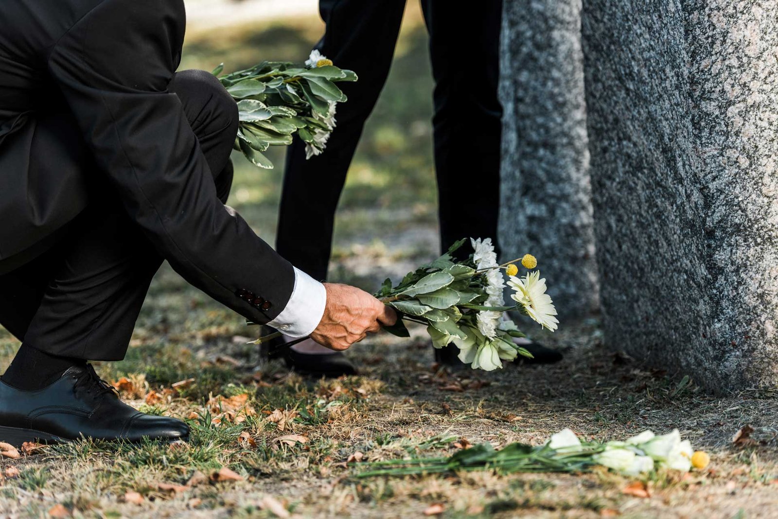 cropped-view-of-senior-man-putting-flowers-near-to-A4V7UQ3.jpg
